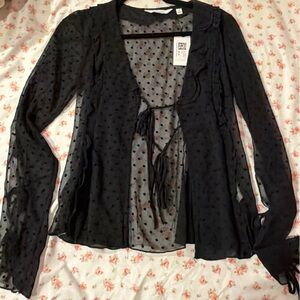 Black sheer polka dot blouse with lace detailing and ruffle trim